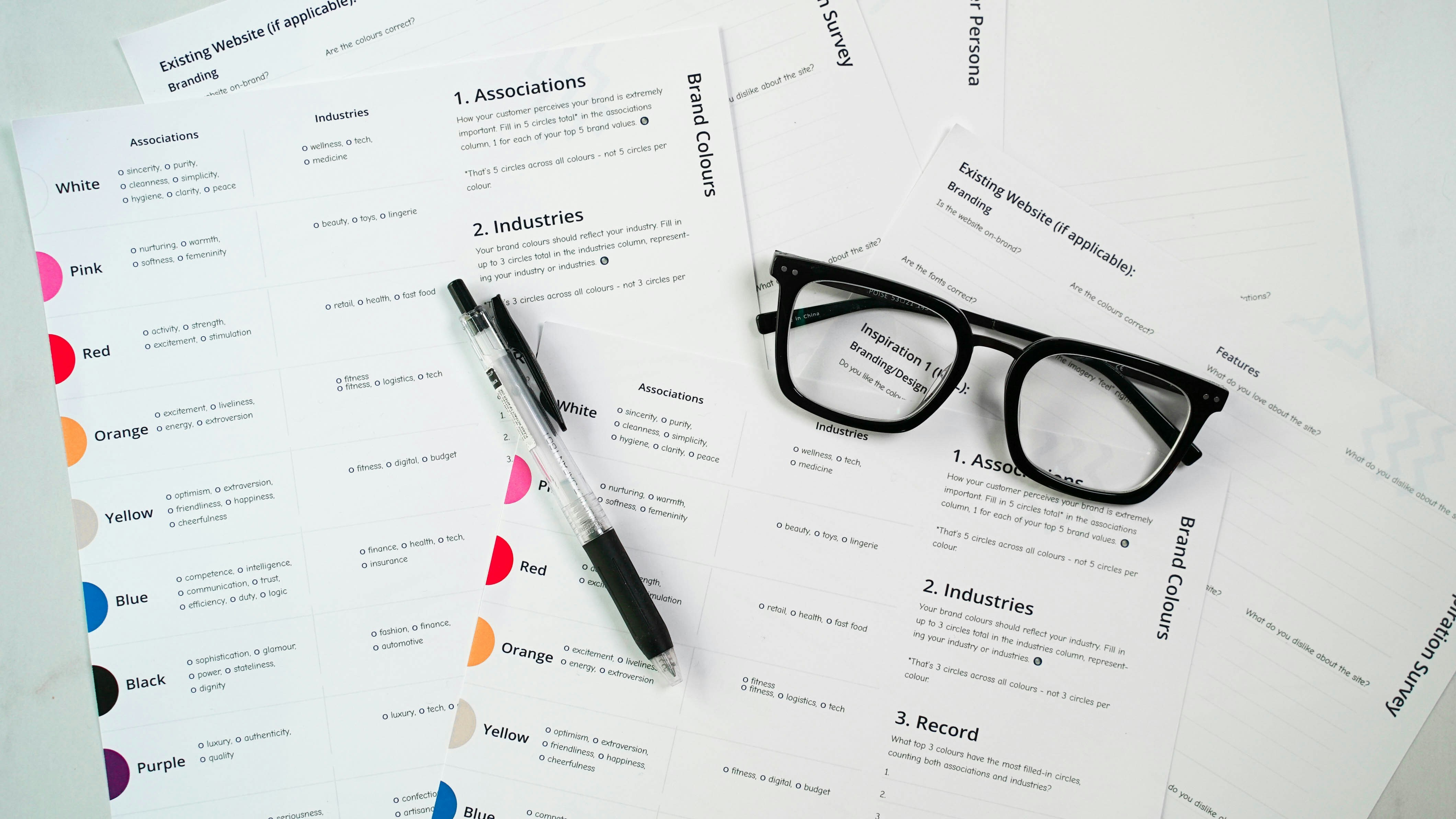 Paperwork, a pen, and eye glasses