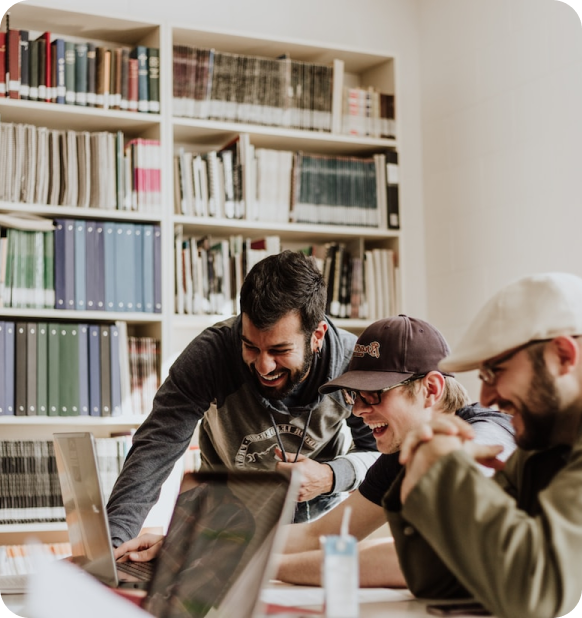 A group of people laughing at the laptop