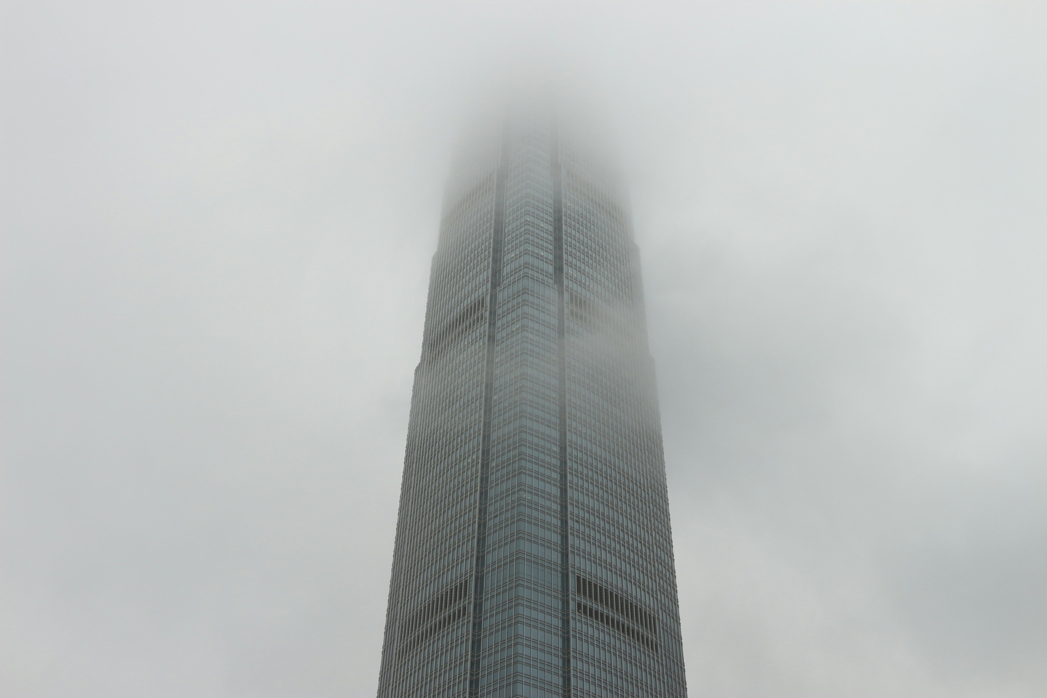 The IFC building covered in dense rainy fog