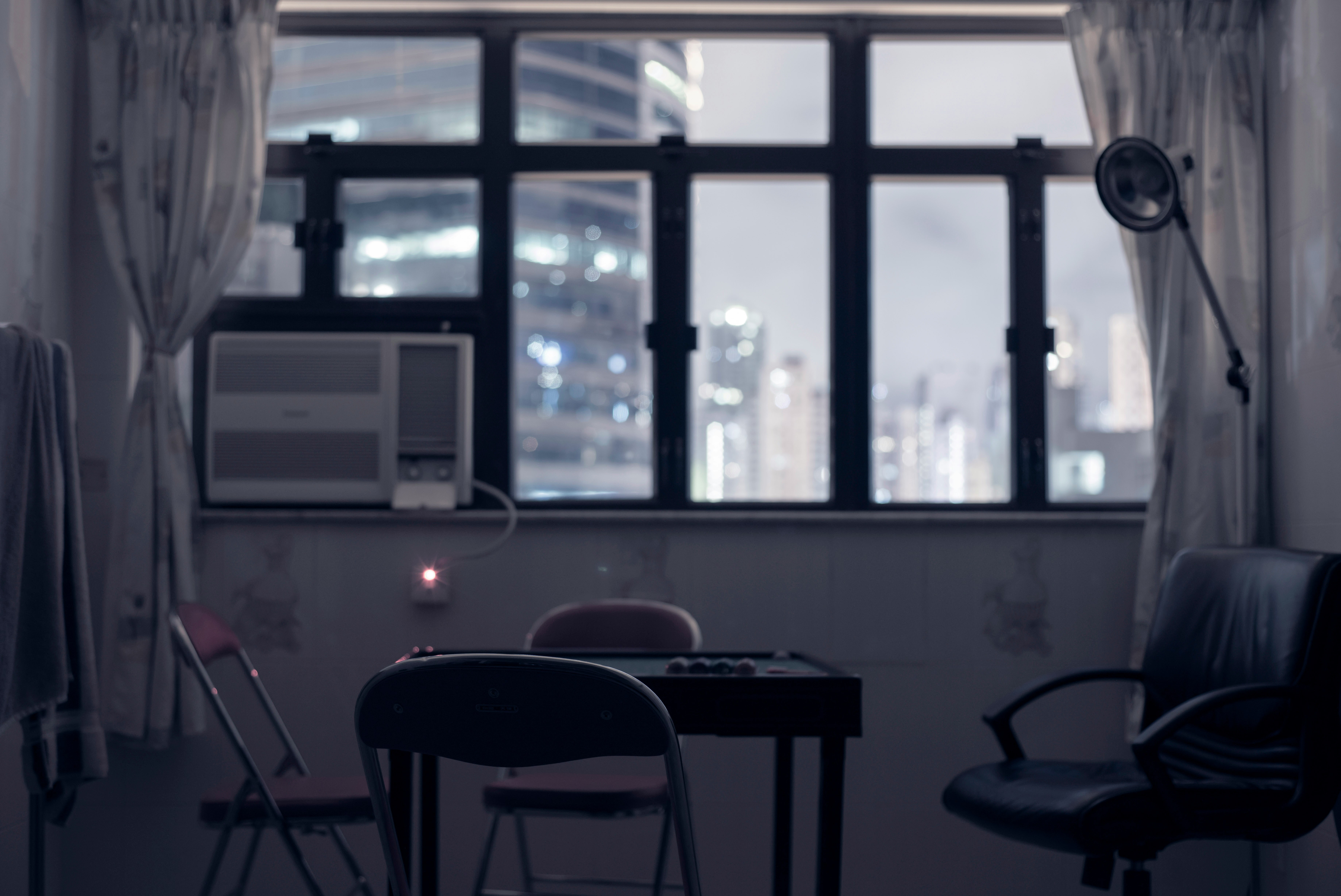 A hong kong apartment, with the window looking out onto a city skyscape