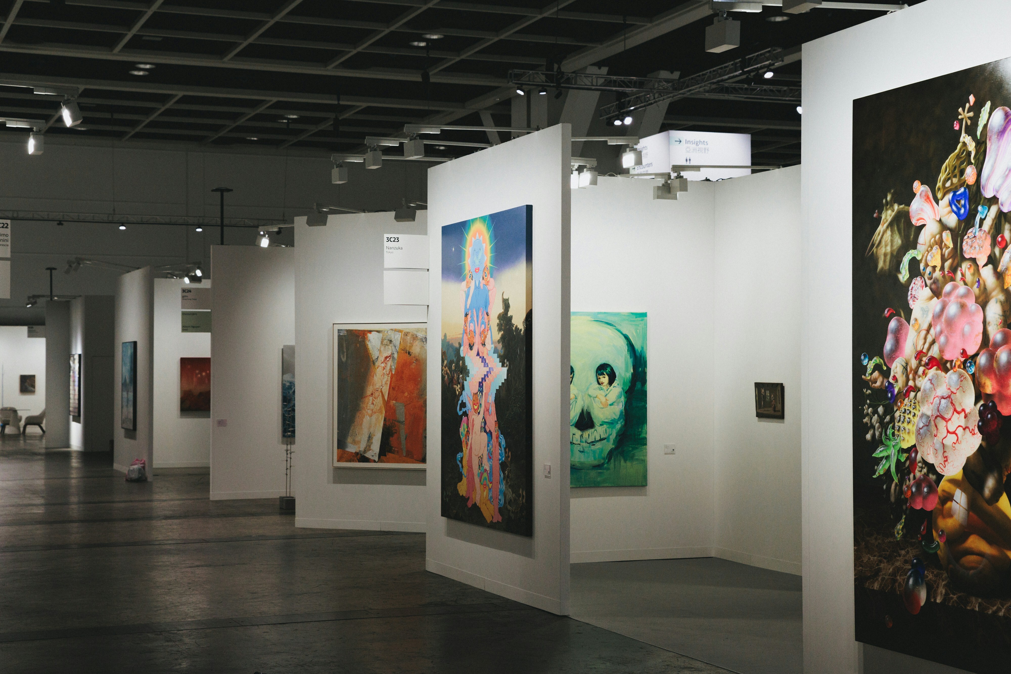 A show room with many paintings and artworks on the wall