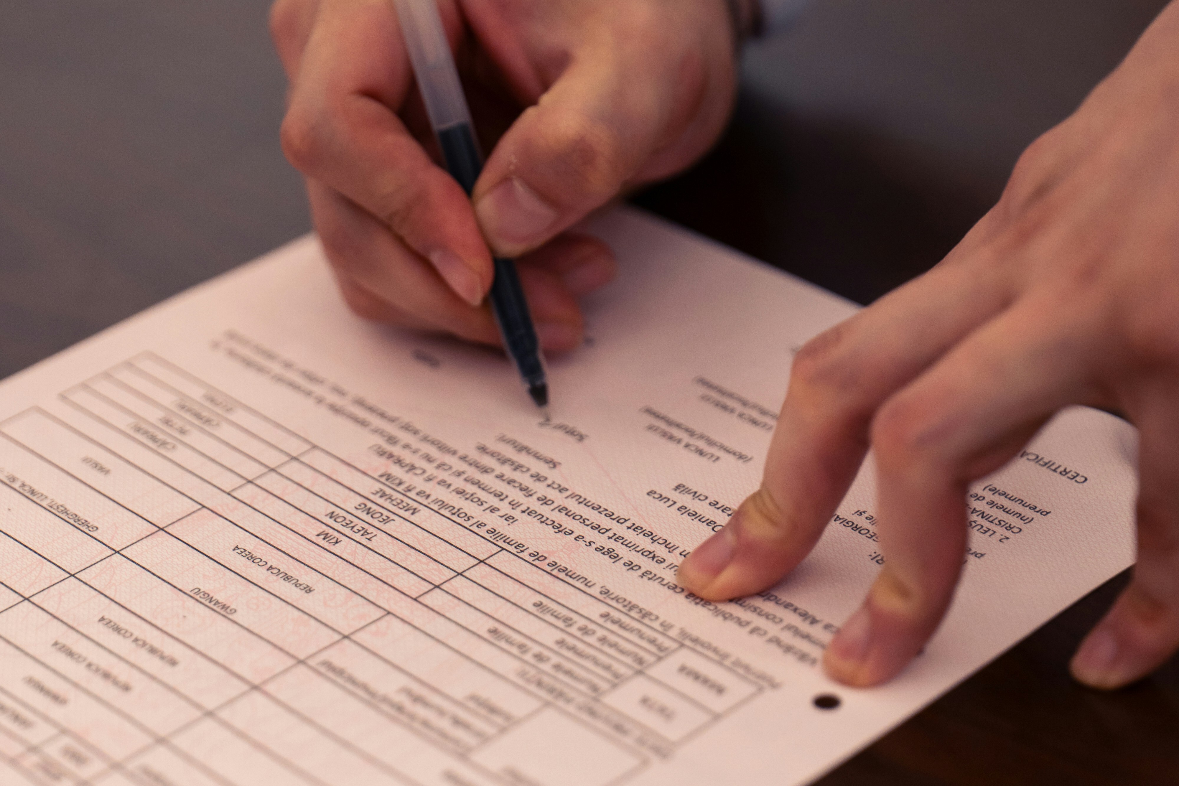 Hands with a pen reviewing paperwork