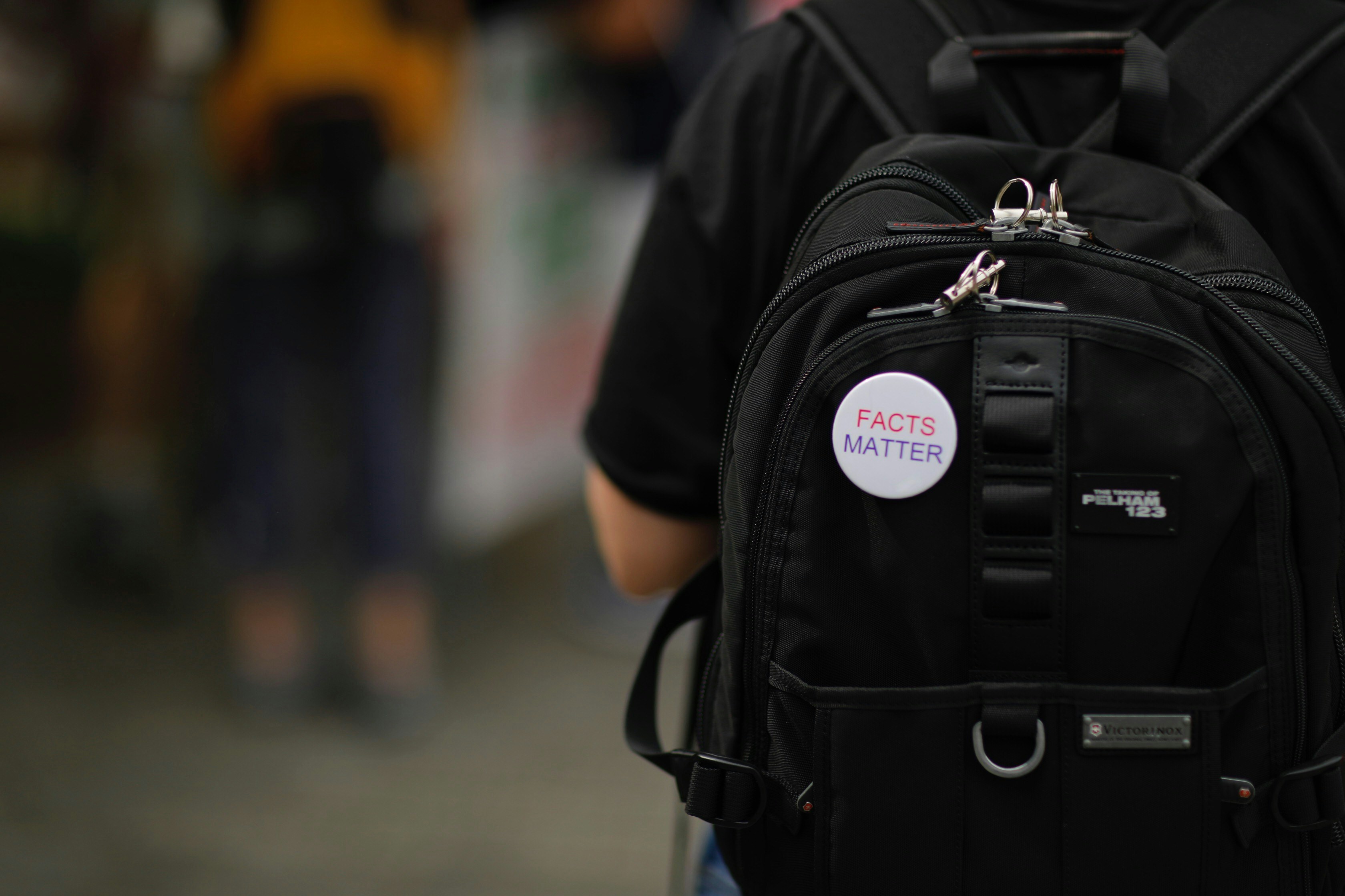 Facts matter pin on a backpack
