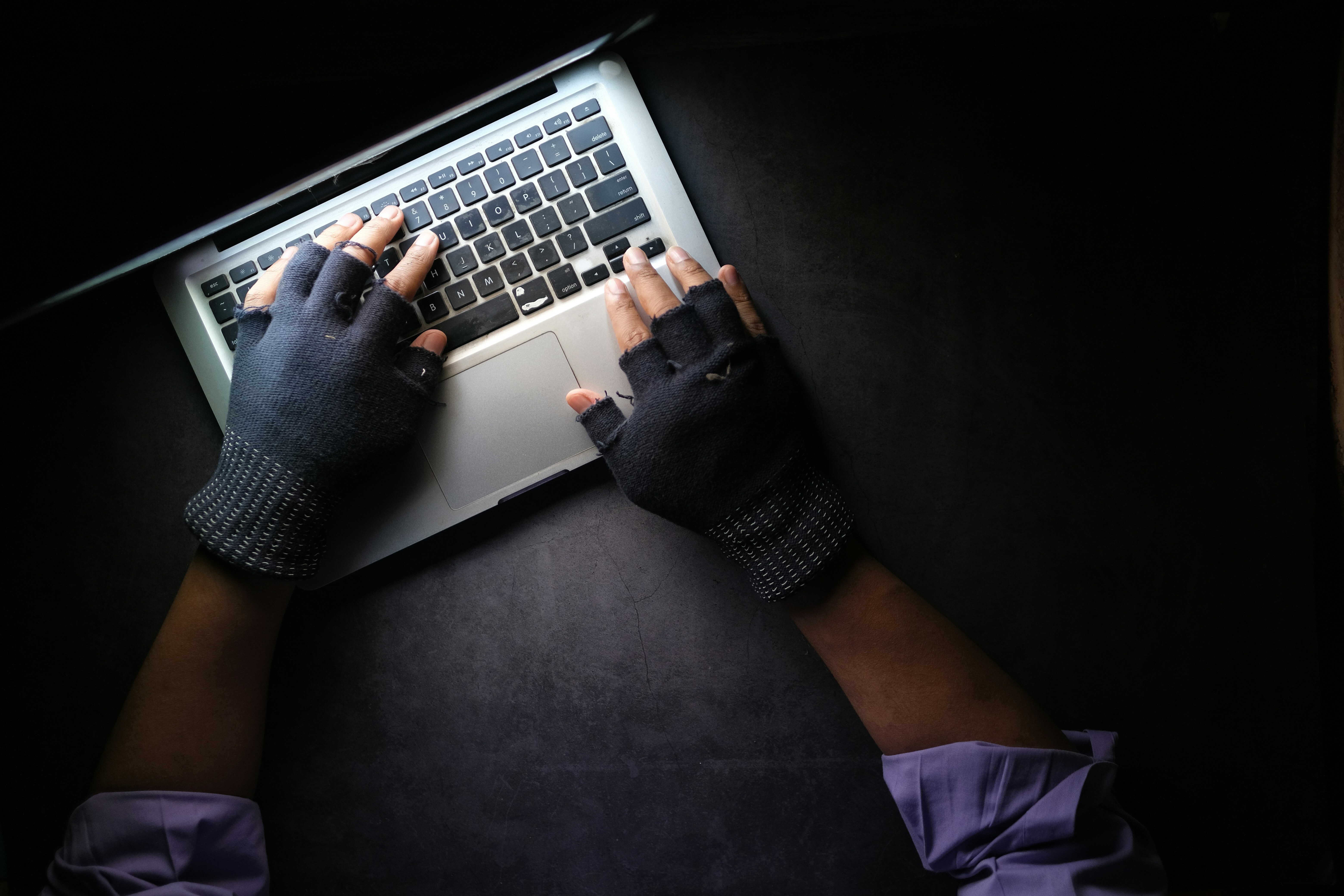 a "criminal" conducting cyber crime on a laptop